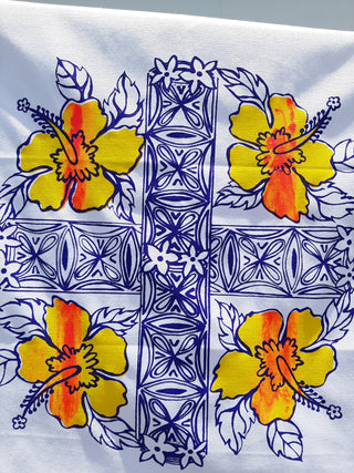 A screen printed Pasifika pattern with yellow and orange hibiscus flowers.