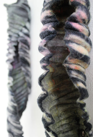 Striped tube-like artwork by tutor Colleen Plank made from felt.