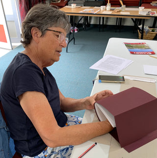 A student works on their book project at the Creative Bookbinding workshop.