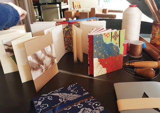 Books bound in unique colours and patterns, created at the Creative Bookbinding workshop.