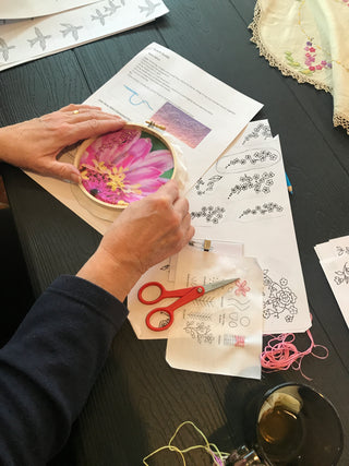 Student works on their embroidery piece in their Embroidered Artwork: Transfer-Stitch Workshop.