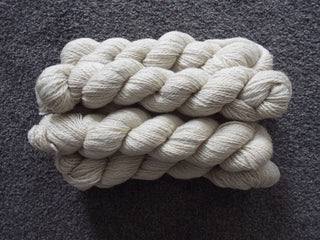 Twisted cream-white yarn made from sheep wool.