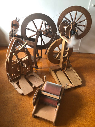Spinning wheels and other tools for processing sheep wool.