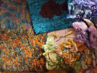 Heirloom Hooked Fleece Rugs in different colours and patterns arranged in a pile with wooden tools.