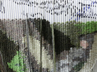 Close-up of an unfinished tapestry.