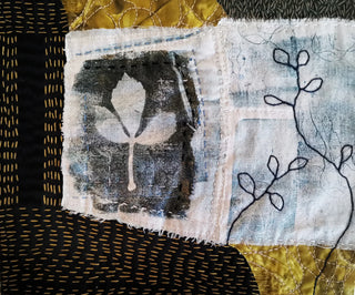 A Textile Collage artwork made up of a patchwork of different coloured fabrics.