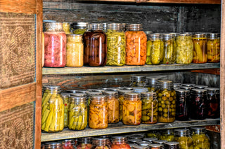 Jars of preserved produce in a pantry.