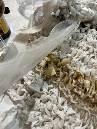 An intricately woven Harakeke Kete Whakairo with light and dark green flax.