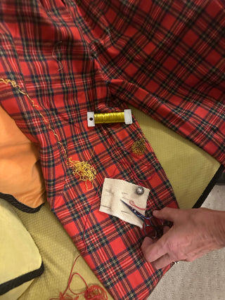 A student works on adding wire, chain and gold thread to their thrifted clothing during the Embellish Me workshop.